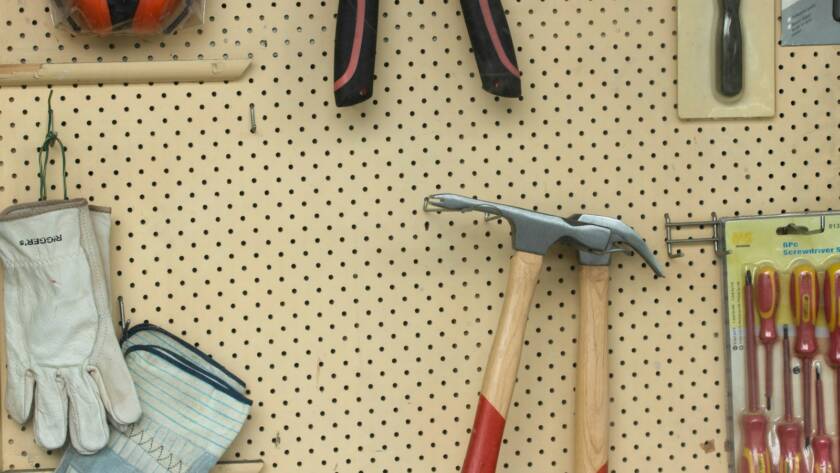 black and silver claw hammer beside red and black hand tool